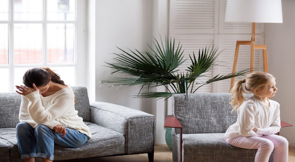 Sad tired mother and sulky daughter not talking after conflict